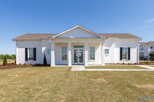 view of front of home featuring french doors and a front yard