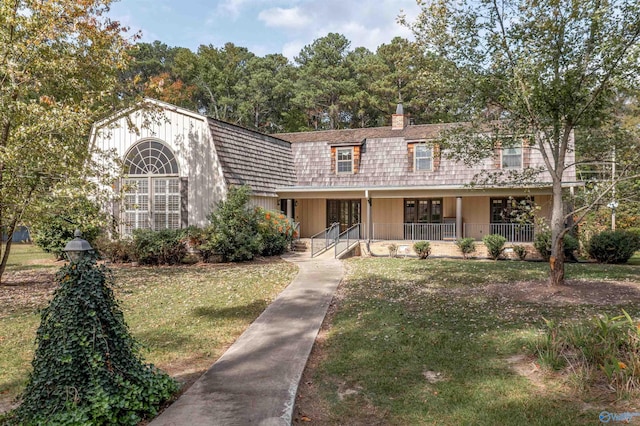 view of front of home with a porch and a front lawn