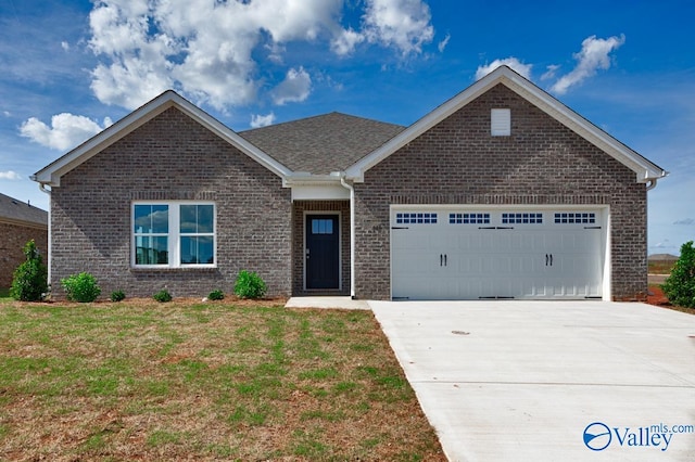 view of front of house featuring a garage and a front lawn