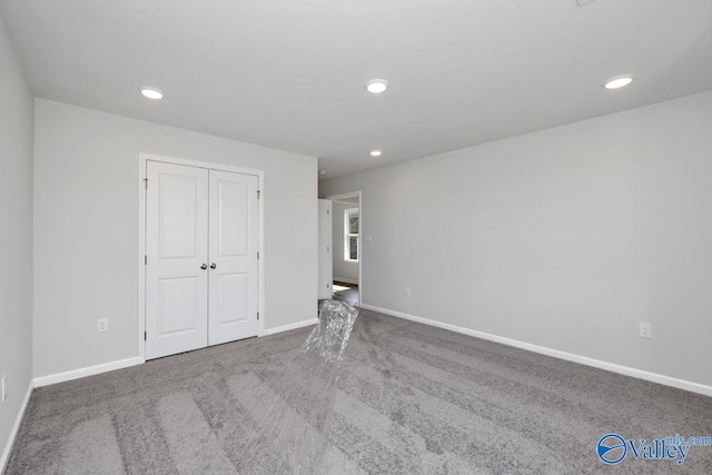 unfurnished bedroom featuring a closet and carpet