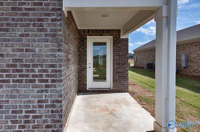 property entrance with a patio and central air condition unit