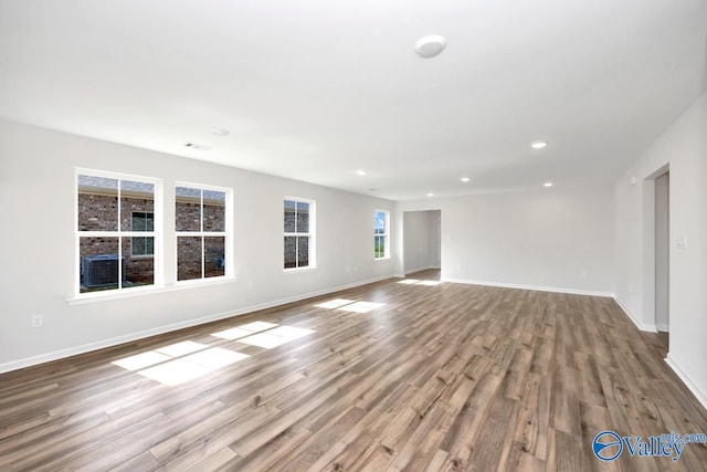 unfurnished living room with wood-type flooring