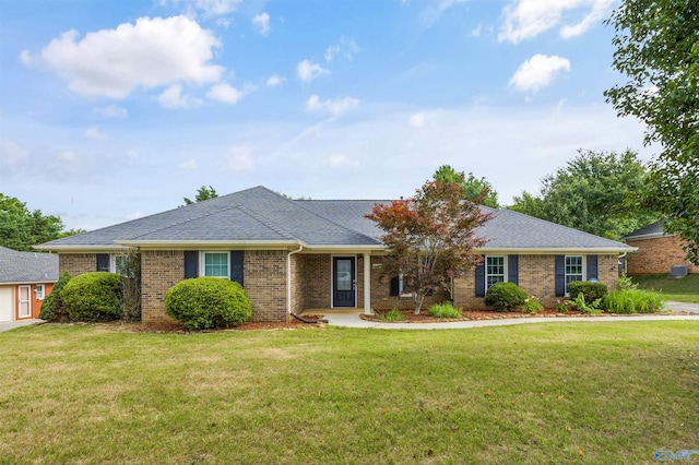 221 Badger Dr, Harvest, AL 35749 - single story home featuring a front yard, brick siding, and a shingled roof