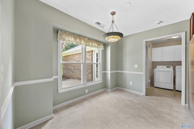 221 Badger Dr, Harvest, AL 35749 - unfurnished dining area featuring independent washer and dryer, a textured ceiling, and baseboards
