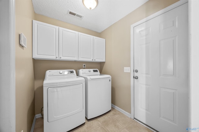 221 Badger Dr, Harvest, AL 35749 - laundry area with washer and clothes dryer, cabinet space, baseboards, and a textured ceiling