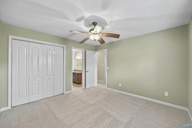 221 Badger Dr, Harvest, AL 35749 - unfurnished bedroom featuring baseboards, carpet, a closet, ensuite bathroom, and a textured ceiling