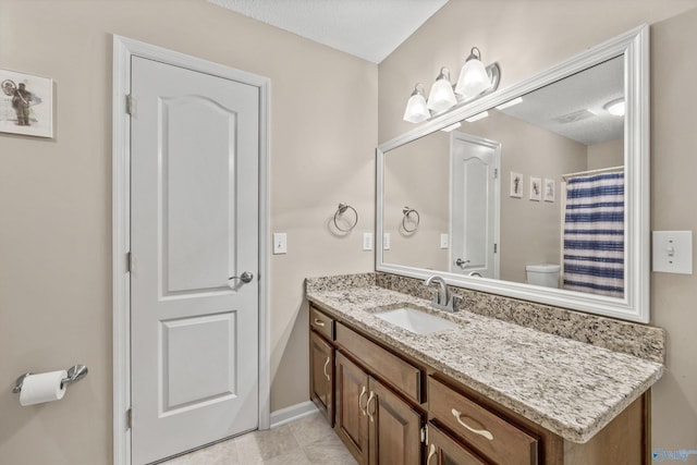 221 Badger Dr, Harvest, AL 35749 - bathroom with vanity, toilet, a textured ceiling, and baseboards