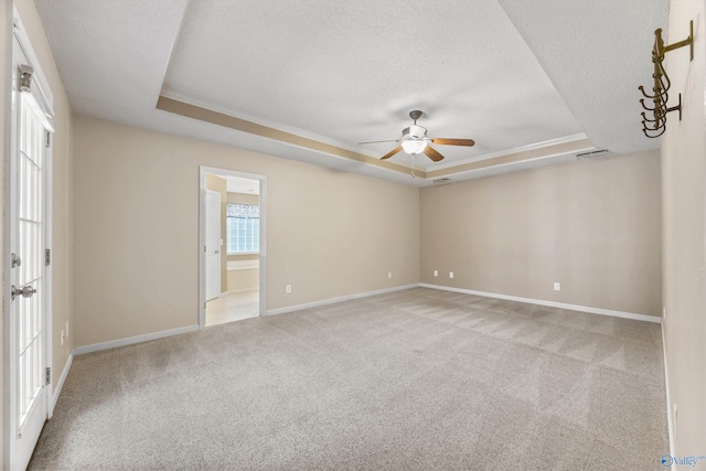 221 Badger Dr, Harvest, AL 35749 - empty room with a tray ceiling, ceiling fan, light colored carpet, a textured ceiling, and baseboards