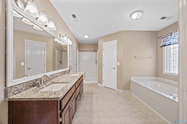 221 Badger Dr, Harvest, AL 35749 - full bathroom featuring a stall shower, double vanity, a bath, and baseboards