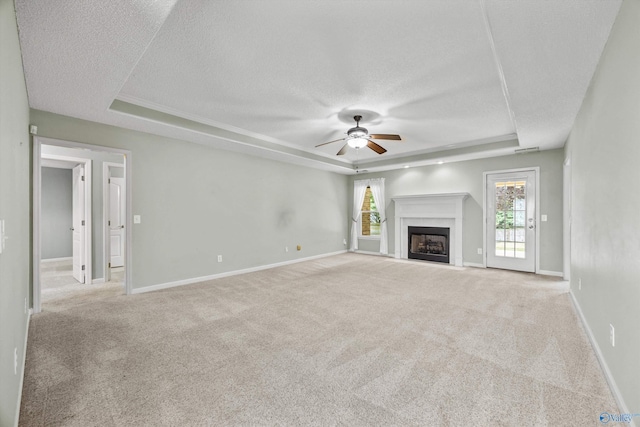221 Badger Dr, Harvest, AL 35749 - unfurnished living room featuring a raised ceiling, a textured ceiling, a ceiling fan, carpet flooring, and baseboards