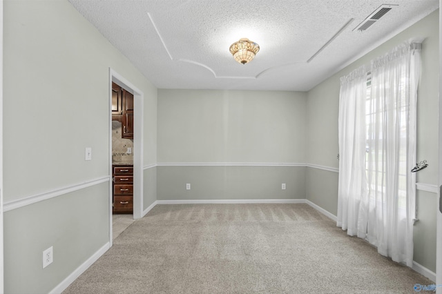221 Badger Dr, Harvest, AL 35749 - unfurnished room with a textured ceiling, light colored carpet, and baseboards