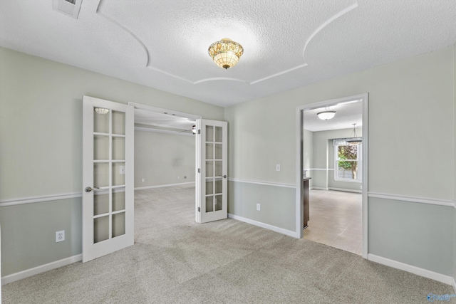 221 Badger Dr, Harvest, AL 35749 - carpeted empty room featuring french doors, a textured ceiling, and baseboards
