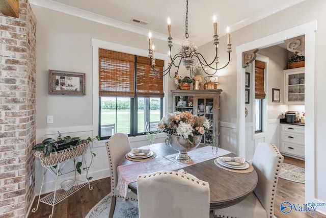 dining space featuring brick wall and wood-type flooring