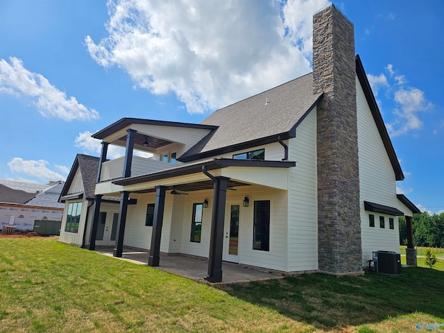 rear view of property featuring a patio area, a lawn, central AC unit, and ceiling fan