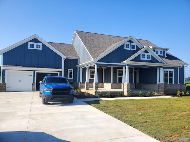 craftsman-style home featuring a garage, a porch, and a front lawn