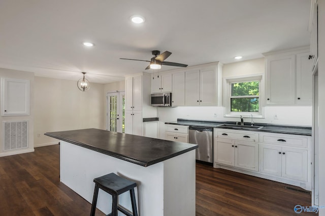 3621 Al Highway 36, Moulton, AL 35650 - kitchen with appliances with stainless steel finishes, dark countertops, a sink, dark wood-style flooring, and recessed lighting