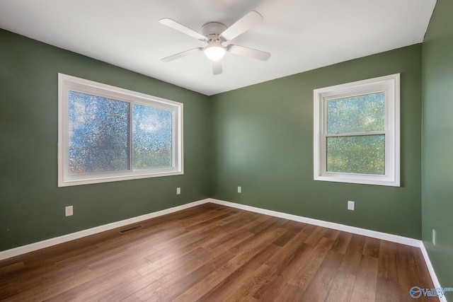 3621 Al Highway 36, Moulton, AL 35650 - spare room with dark wood-style floors, baseboards, and a ceiling fan