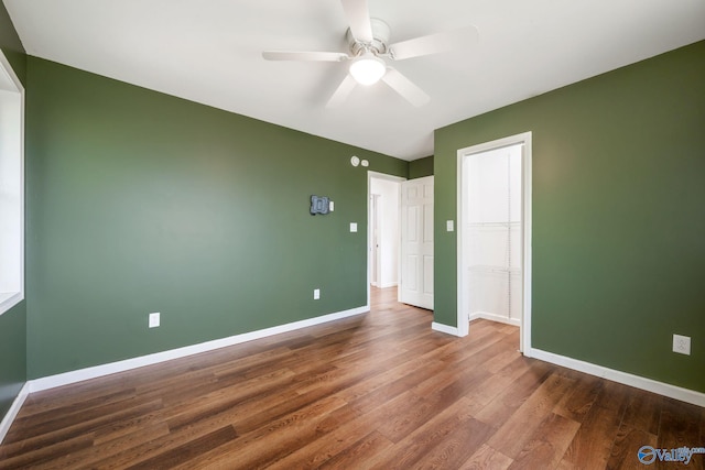 3621 Al Highway 36, Moulton, AL 35650 - unfurnished bedroom with dark wood finished floors, baseboards, ceiling fan, and a closet