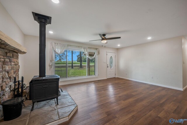 3621 Al Highway 36, Moulton, AL 35650 - unfurnished living room with a wood stove, a ceiling fan, wood finished floors, baseboards, and recessed lighting