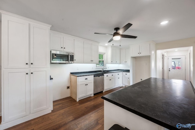 3621 Al Highway 36, Moulton, AL 35650 - kitchen with stainless steel appliances, a sink, dark wood-style flooring, a ceiling fan, and dark countertops