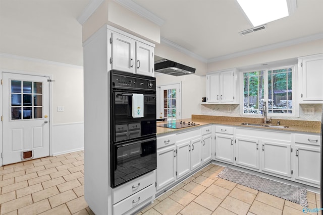 kitchen featuring white cabinetry, black appliances, sink, and decorative backsplash