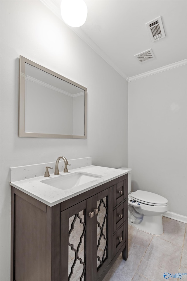 bathroom featuring vanity, toilet, tile patterned floors, and ornamental molding