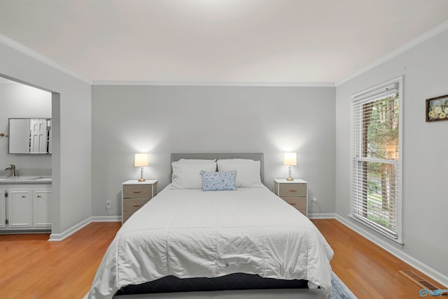 bedroom with crown molding and light wood-type flooring