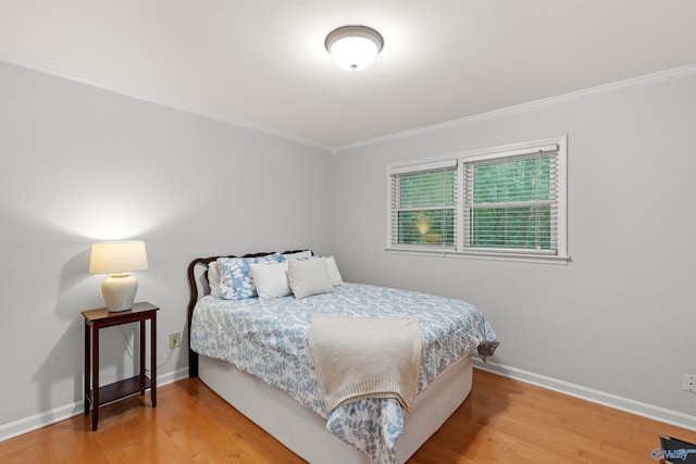 bedroom featuring crown molding and hardwood / wood-style floors