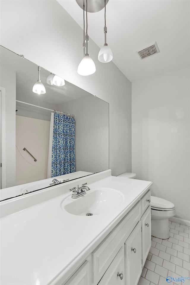 bathroom featuring toilet, a shower with curtain, vanity, and tile patterned flooring