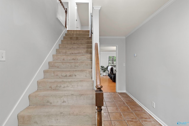 staircase featuring tile patterned floors and ornamental molding