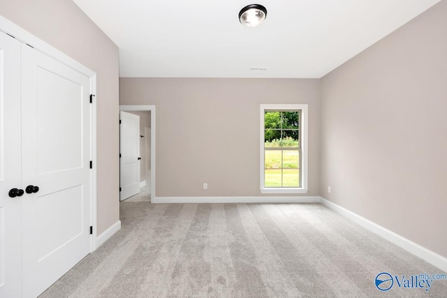 unfurnished room with light colored carpet