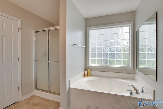 bathroom featuring separate shower and tub and a wealth of natural light