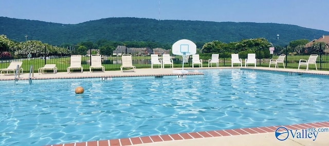 view of swimming pool featuring a mountain view