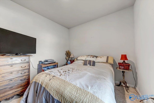 carpeted bedroom featuring lofted ceiling