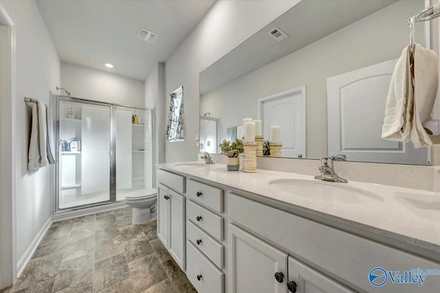 bathroom featuring an enclosed shower, vanity, and toilet