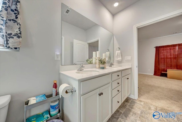 bathroom featuring vanity and toilet