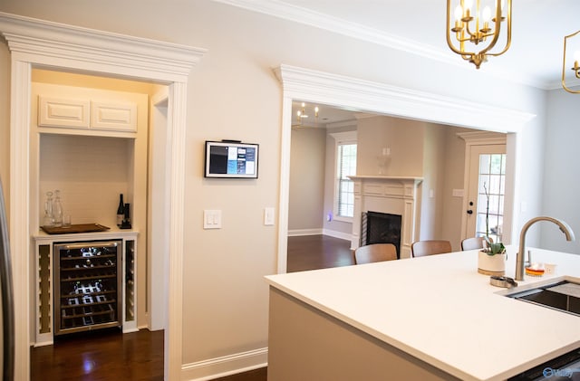 kitchen with sink, wine cooler, ornamental molding, dark hardwood / wood-style flooring, and decorative backsplash