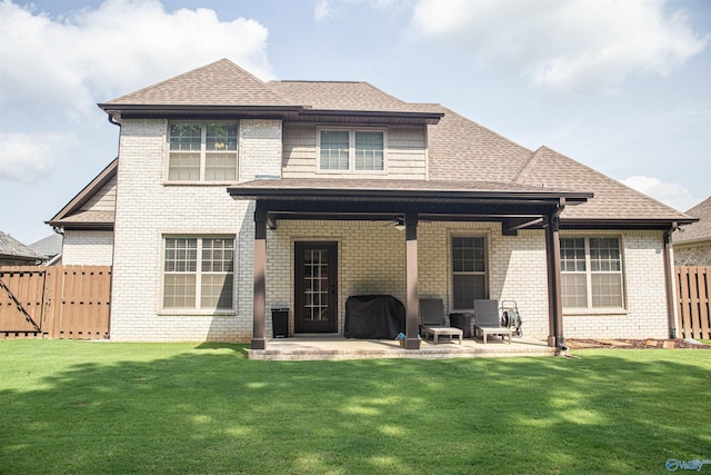 rear view of house with a lawn and a patio area