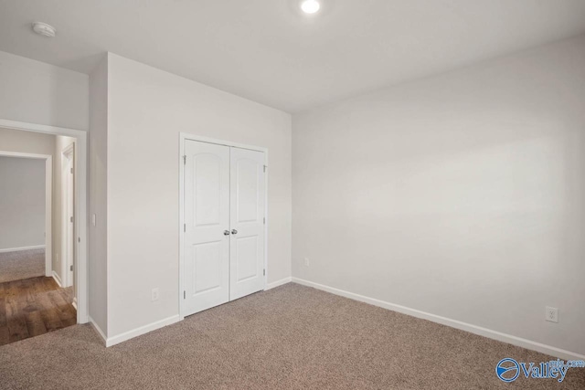 unfurnished bedroom with carpet floors and a closet