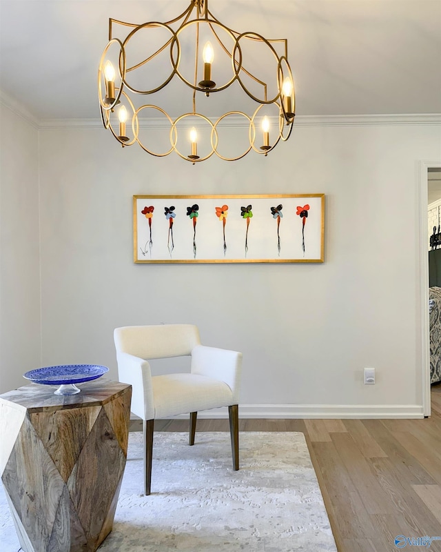 living area featuring crown molding and light hardwood / wood-style floors