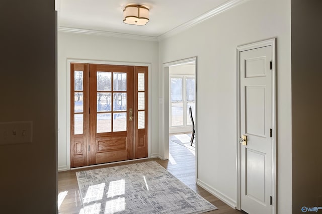 foyer entrance with crown molding and light hardwood / wood-style flooring