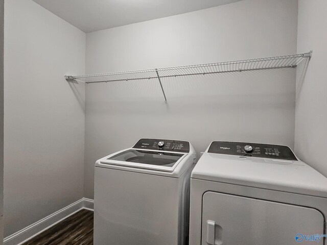 laundry area with laundry area, dark wood-type flooring, baseboards, and separate washer and dryer