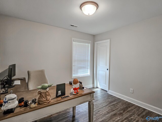 office space featuring visible vents, baseboards, and dark wood-type flooring