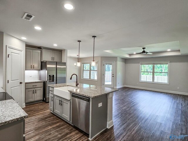 kitchen with visible vents, appliances with stainless steel finishes, gray cabinetry, and a sink