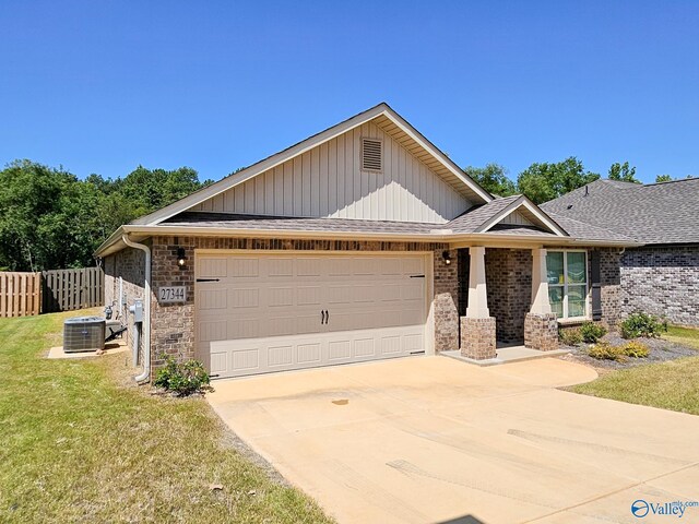 ranch-style house with fence, concrete driveway, a front yard, roof with shingles, and a garage
