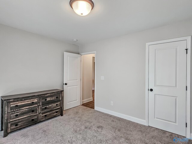unfurnished bedroom with carpet flooring and baseboards