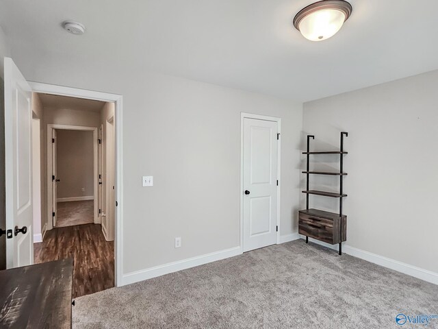 unfurnished bedroom with carpet and baseboards