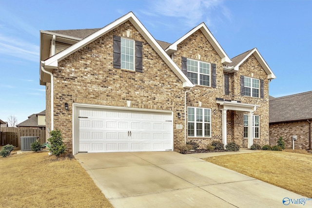 view of front facade featuring a garage, central AC, and a front yard