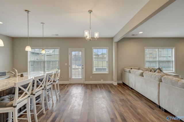 interior space with a healthy amount of sunlight, sink, and dark hardwood / wood-style floors