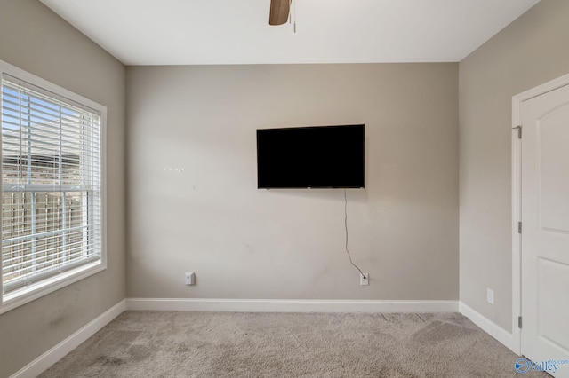 interior space with ceiling fan